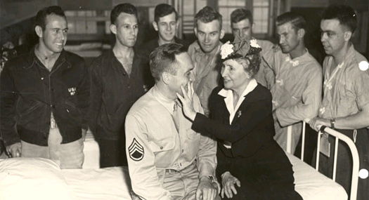 Helen touches the face of a wounded soldier at a hospital in North Carolina, 1945