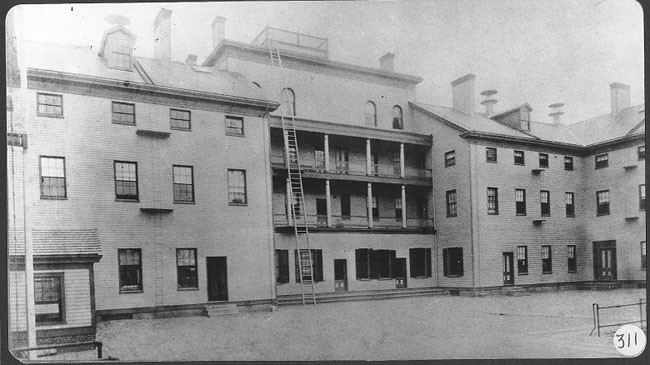 Photograph of the Tewksbury Almshouse, circa 1890. This three-story wooden structure was erected circa 1854-1858. Image courtesy of the Public Health Museum, Tewksbury, Massachusetts.