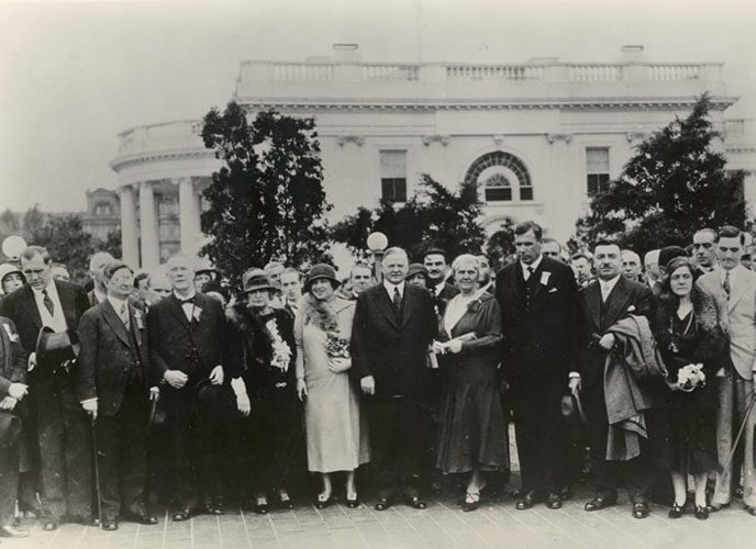 Helen Keller, President Herbert Hoover, and international delegates outside the White House, 1932