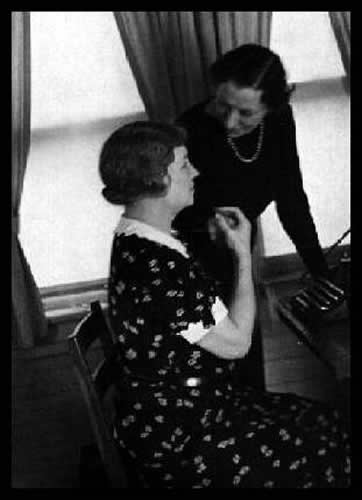 Helen at the typewriter, Polly Thomson standing beside her, 1933