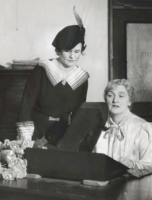 Actor Sybil Thorndike seated in front of a machine at the studios of the American Foundation for the Blind in December 1934. 