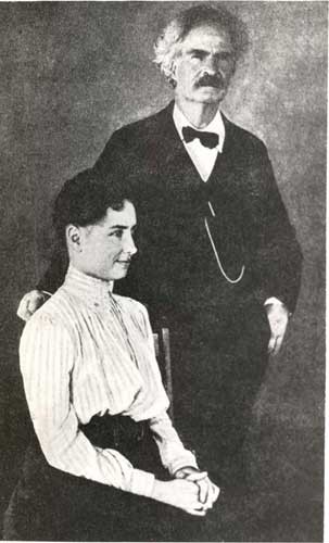 Helen Keller seated with Mark Twain standing behind her chair. 