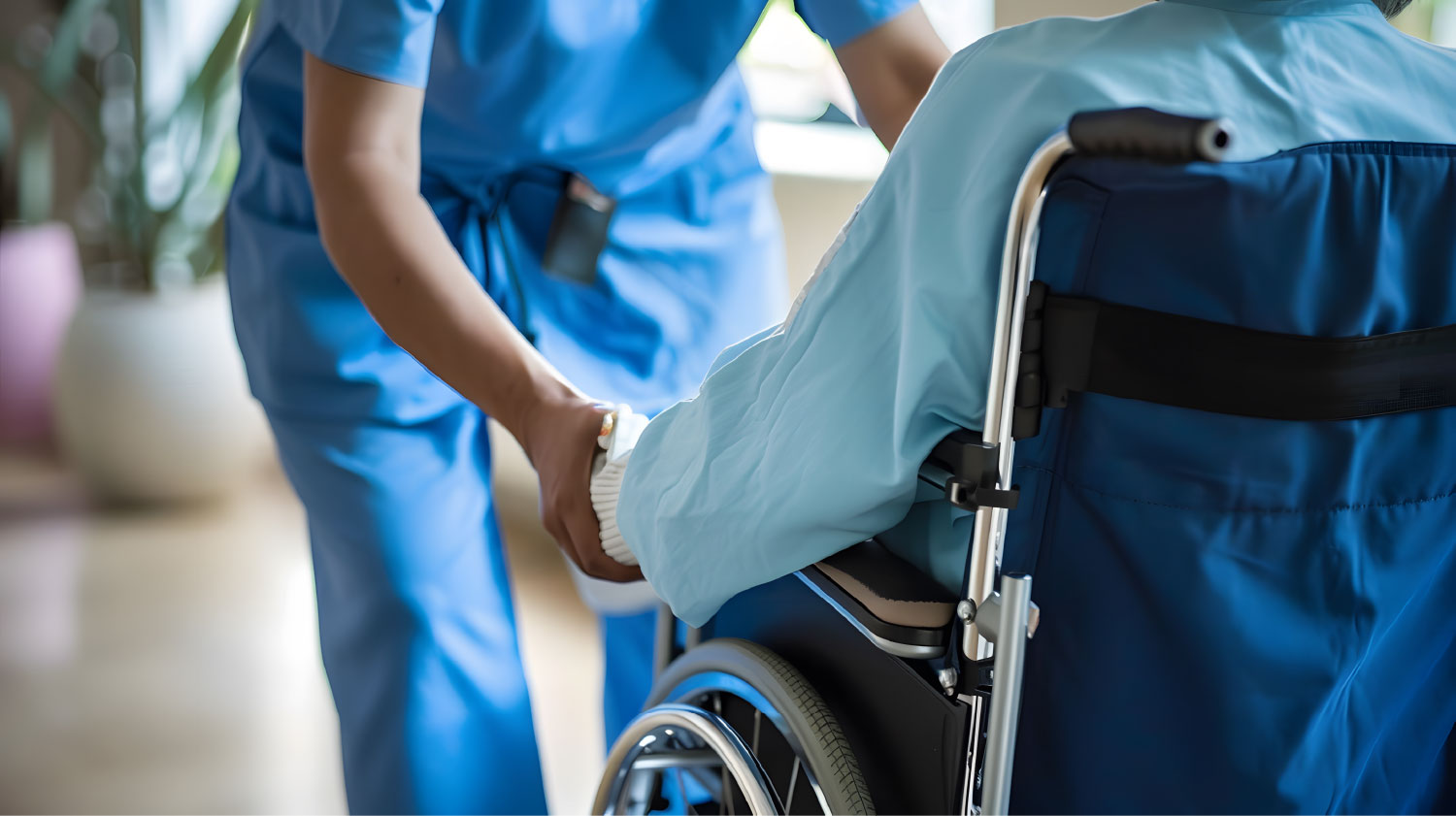 A nurse assisting a patient in a wheelchair.