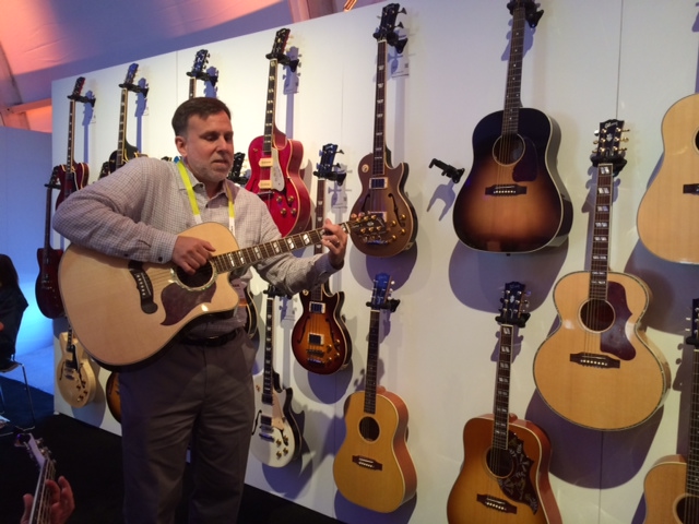 Paul Schroeder playing guitar at the Gibson booth