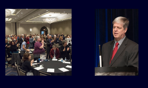 Photo of attendees clapping during the 2017 AFBLC. Photo of Kirk Adams speaking during the 2017 AFBLC.