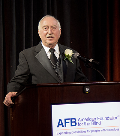 Larry Kimbler at a podium with AFB's logo on it