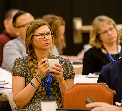 two women at a conference, listening intently