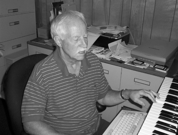 Figure 3: Photograph of Harvey Miller using a piano keyboard and a QWERTY computer keyboard.