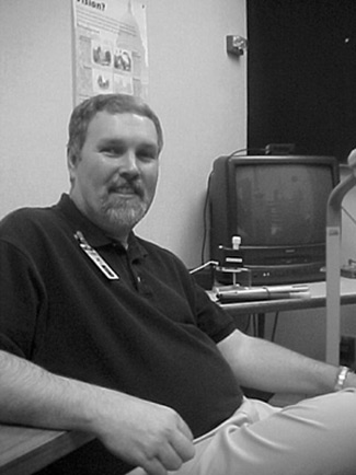 Figure 1: Photograph of Jim Unger seated at a desk.