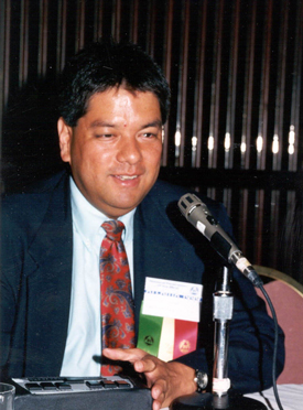  Photo of Curtis Chong speaking at a microphone.