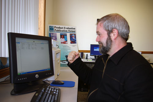 A man shaking his fist at iTunes menu on his screen.