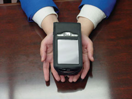 Photo of the Reader being held in the palms of a pair of hands.