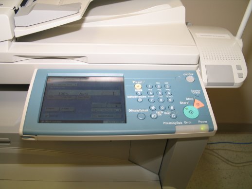 Photo of the imageRUNNER control panel with the Voice Operation speaker on the side.