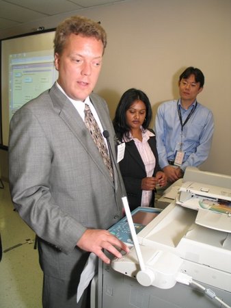 Photo of Canon technicians showing AFB TECH staff member the Voice Operation Kit.