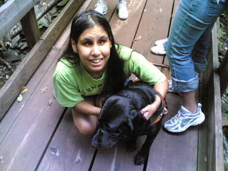 Photo of Martha with her arms around her dog guide.