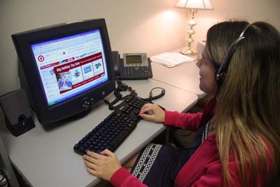 Woman wearing headphones browses Target.com