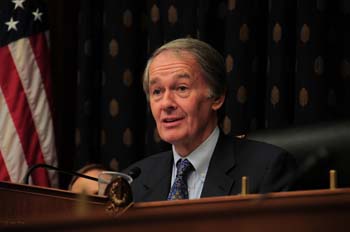 Congressman Edward Markey (D-Mass.) sits at a desk with the American flag displayed at his left.