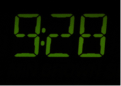 Photo of an emissive, fixed-segment LED screen on an alarm clock