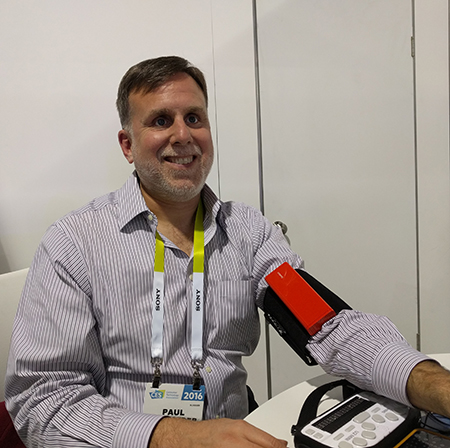 Man seated, with blood pressure monitor on his upper arm