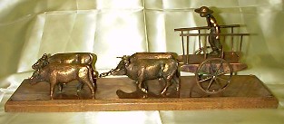 Bronze Sculpture of a Man and his Oxen