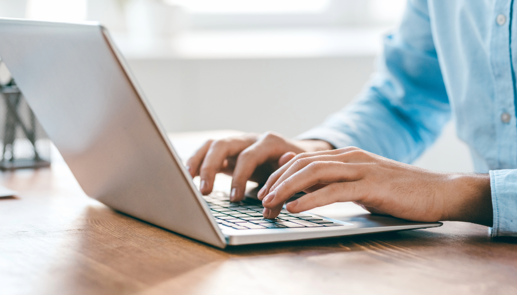 A person presses keys on their computer.